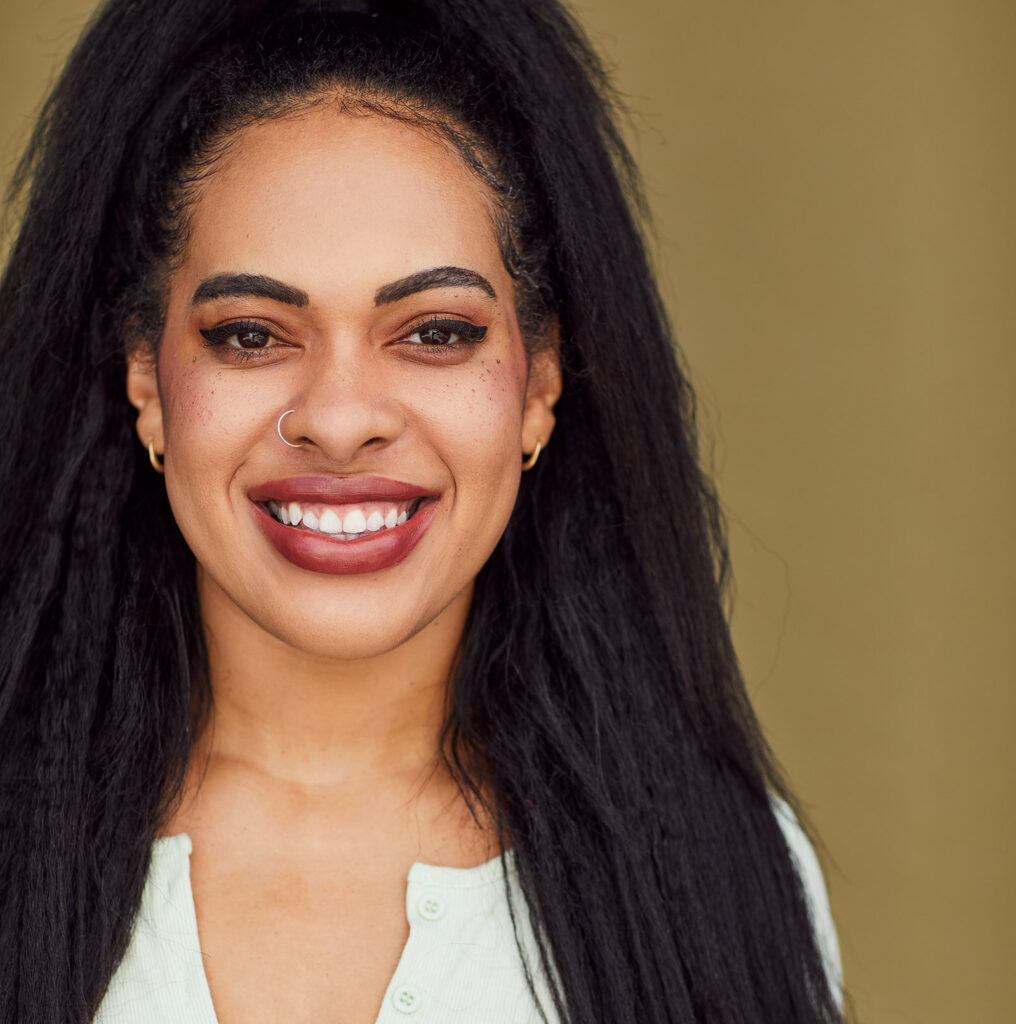 A woman with long black hair smiling for the camera.