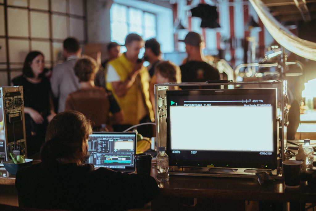 A person sitting at a desk with a laptop and computer.