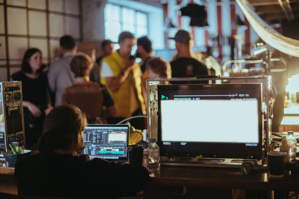 A person sitting at a desk with two computers.