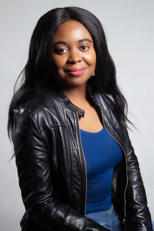 A woman in a black jacket and blue shirt