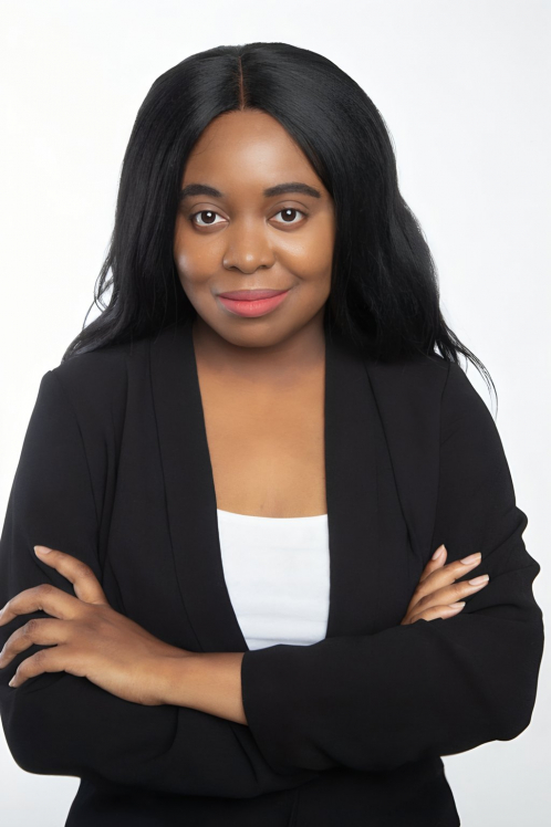 A woman with long black hair wearing a white shirt and jacket.