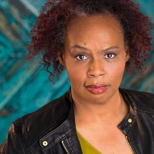 A woman with curly hair and a yellow shirt