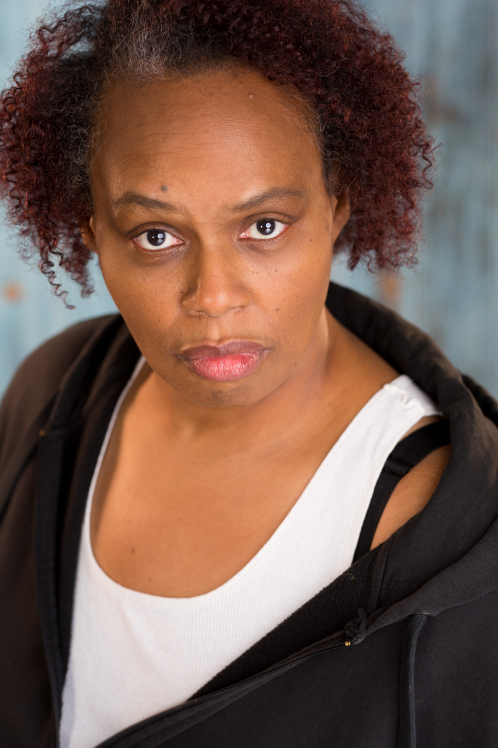 A woman with red hair and a white shirt