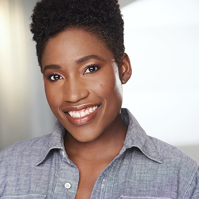 A woman with short hair is smiling for the camera.