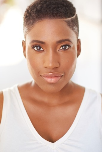 A woman with short hair is posing for the camera.